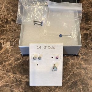 Assorted titanium, stainless, fake diamond earrings.